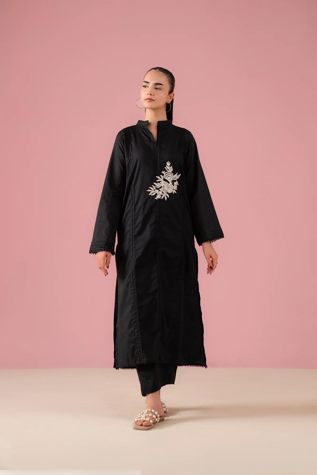 Black co ord set for women in Pakistan featuring embroidered lawn kurta with band collar and matching black trousers