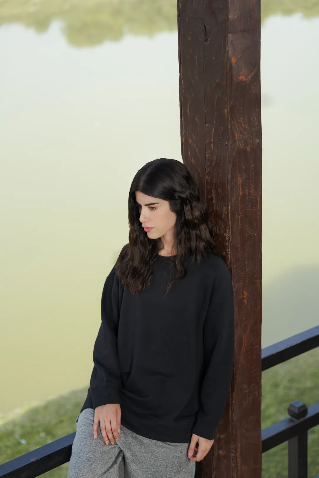 Black sweatshirt casual look on model near outdoor setting