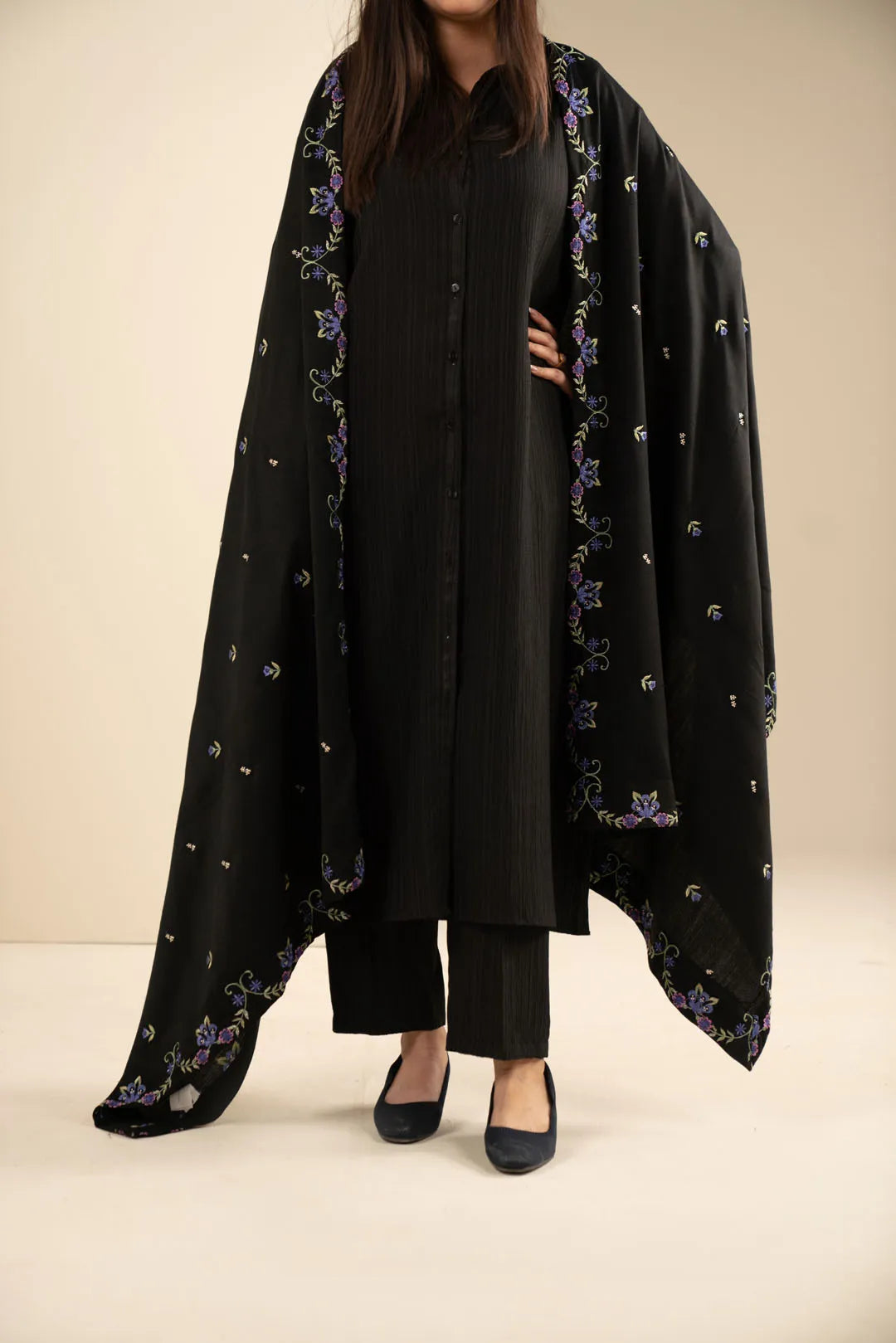 Black yarn dyed embroidered shawl draped over a black outfit, front view with full coverage.