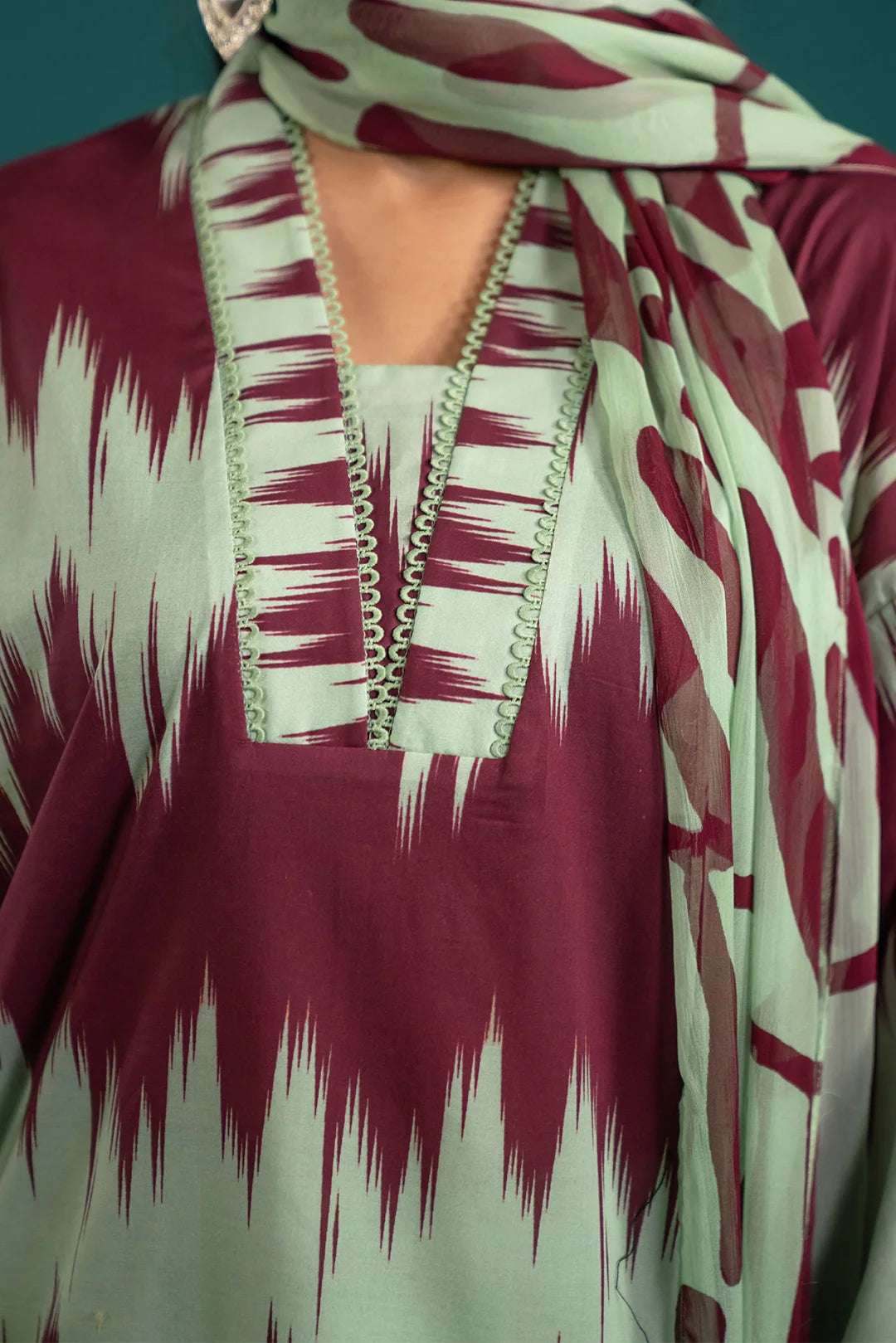 Bold and elegant digital printed lawn suit with a contemporary ikkat pattern and soft chiffon dupatta – perfect for festive and casual wear.