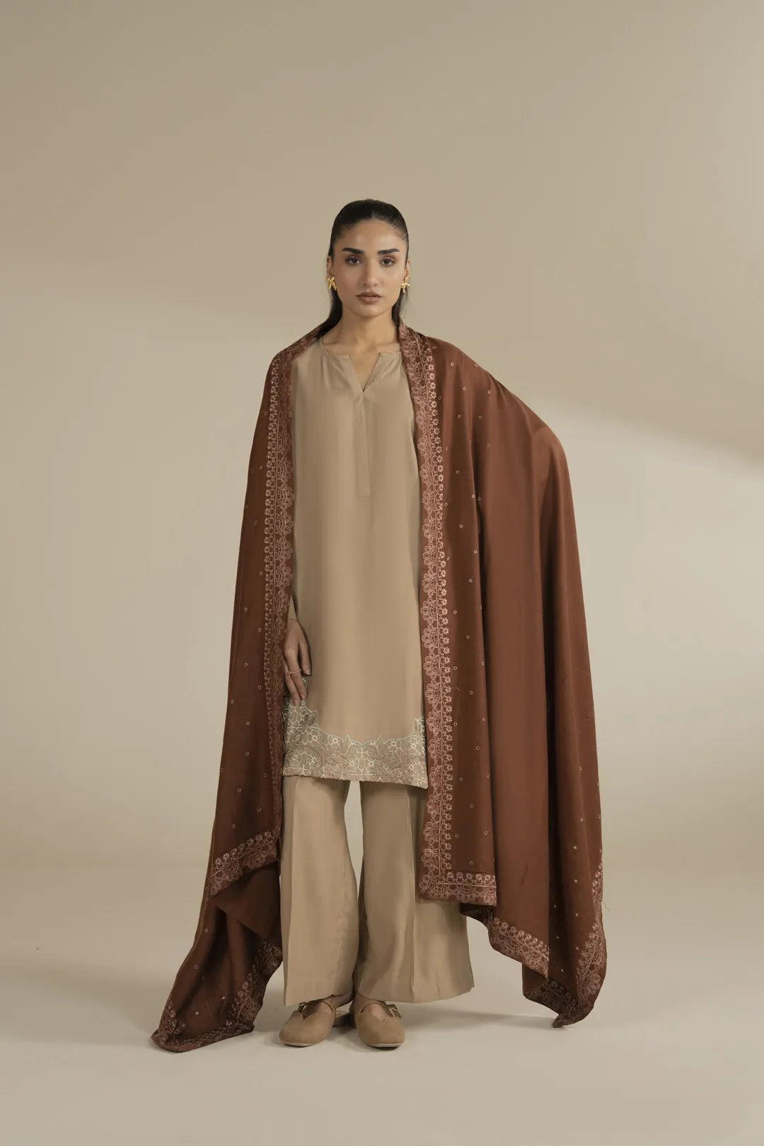 Brown yarn dyed embroidered shawl styled as a full drape over a neutral outfit, front view in studio.