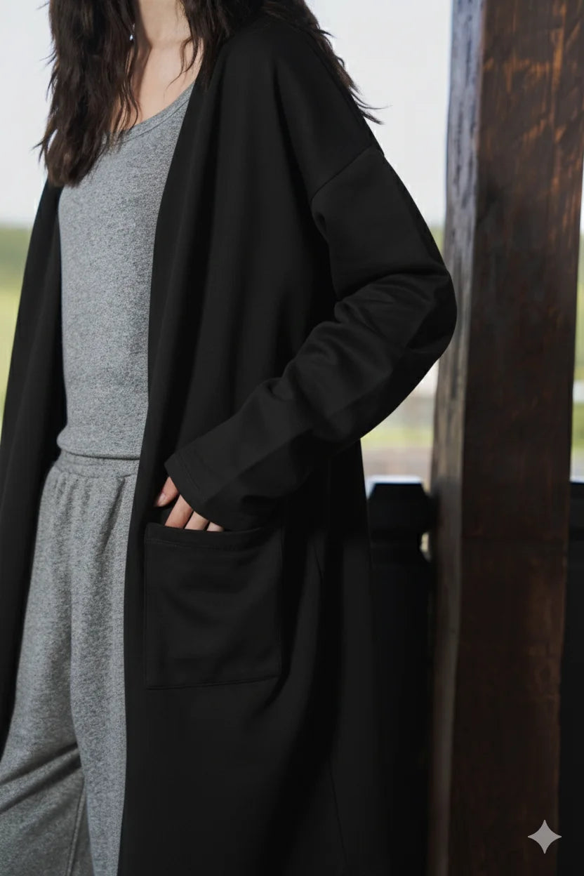 Close-up angle highlighting the black cardigan front pocket and open-front design.