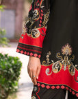 Close-up detail of black and red printed cambric sleeve and trouser design