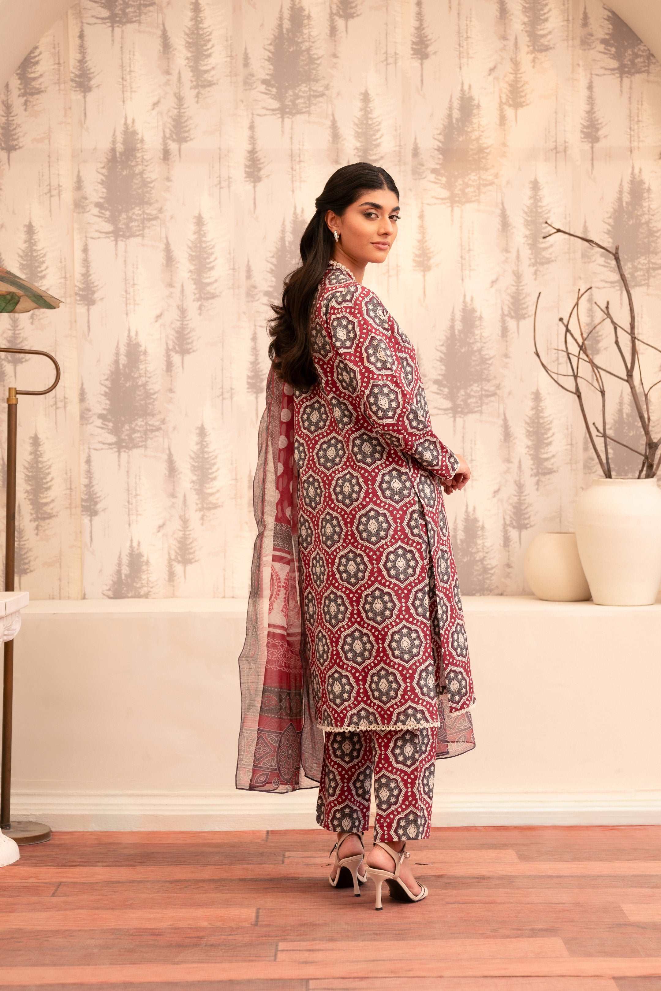Close-up of a maroon and grey printed kurta with intricate neckline and lace detailing.