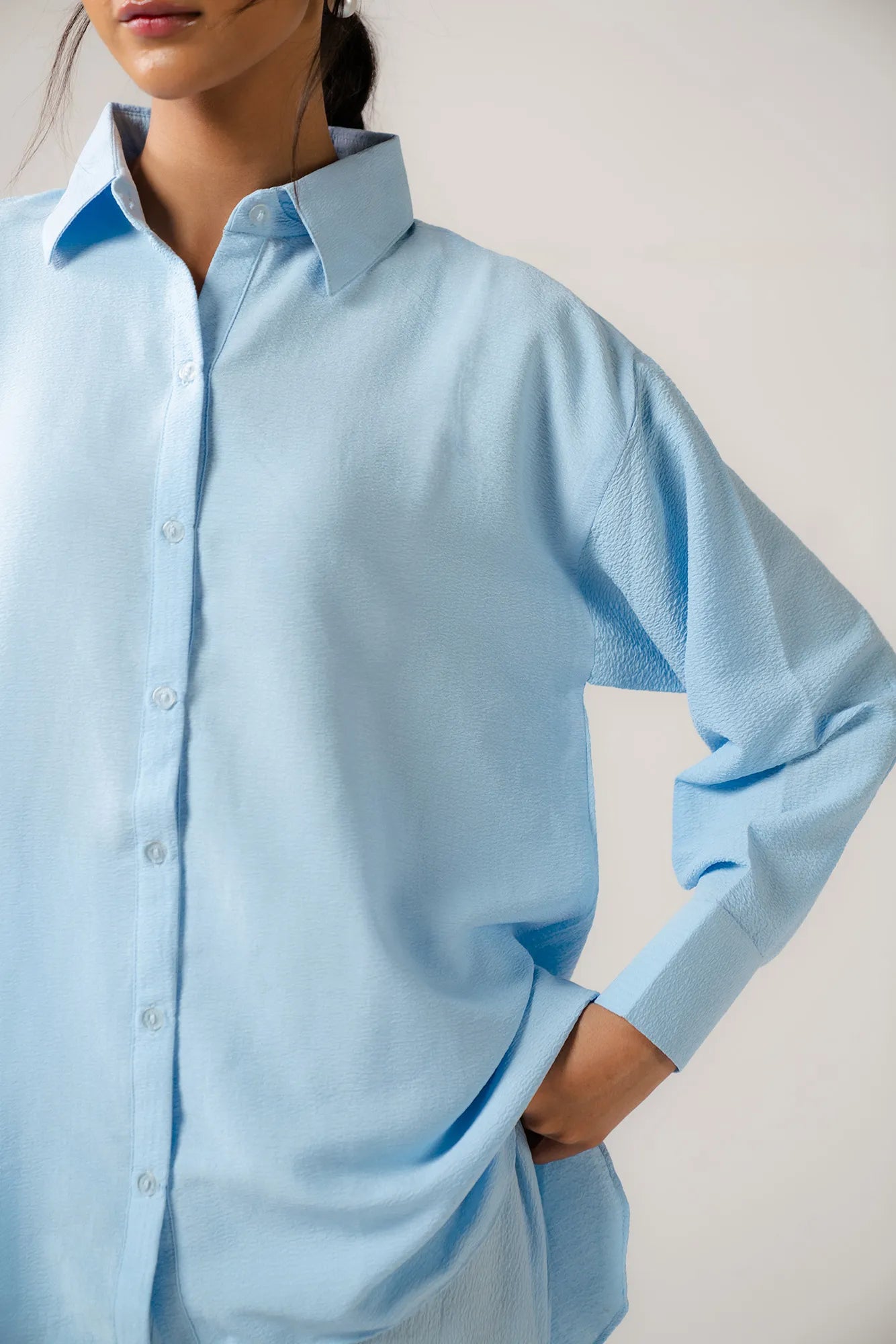 Close-up of a premium ladies poplin shirt, showing the smooth, woven texture and clean lines of the durable cotton fabric