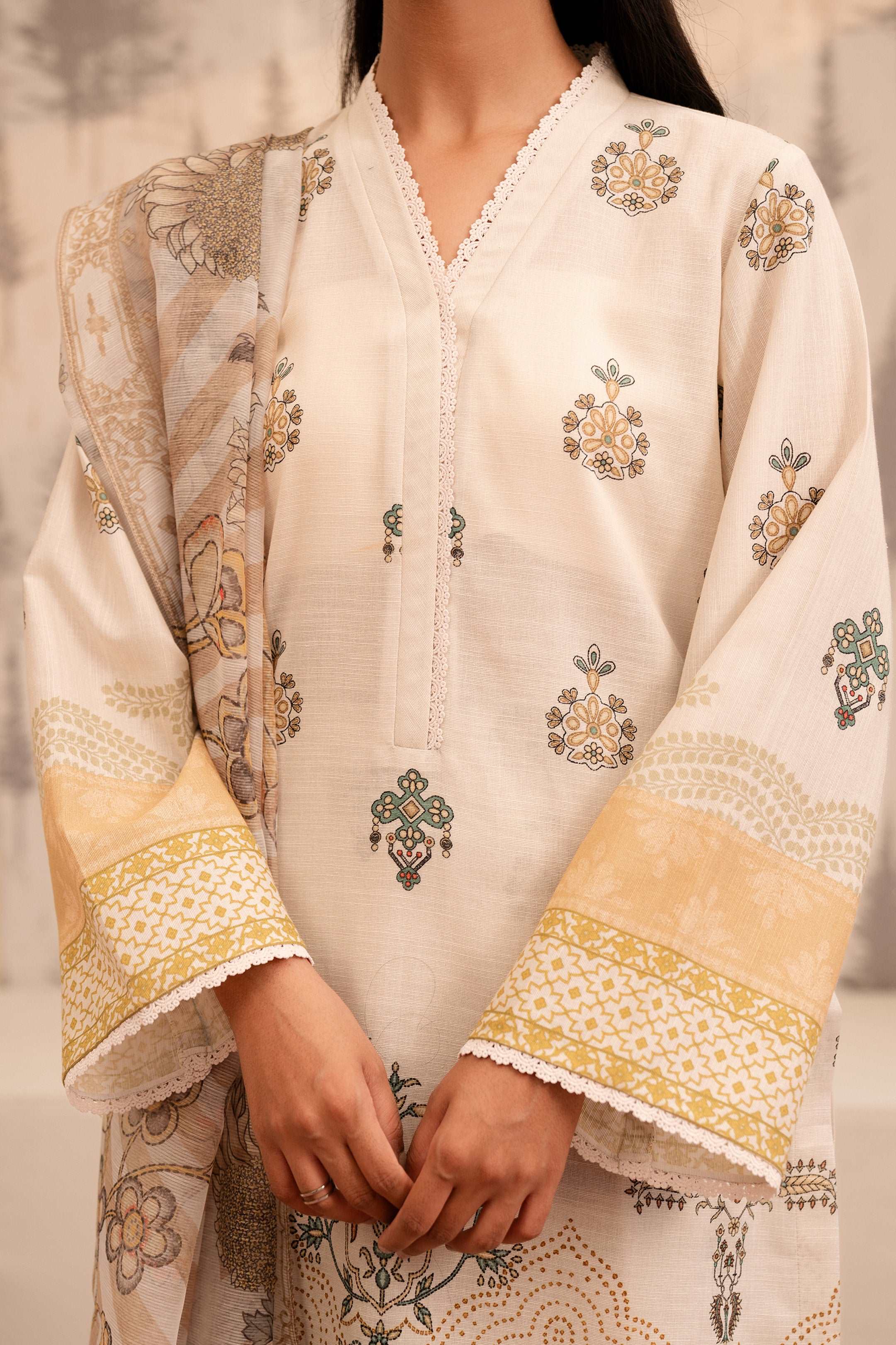 Close-up of an off-white embroidered shirt with lace detailing