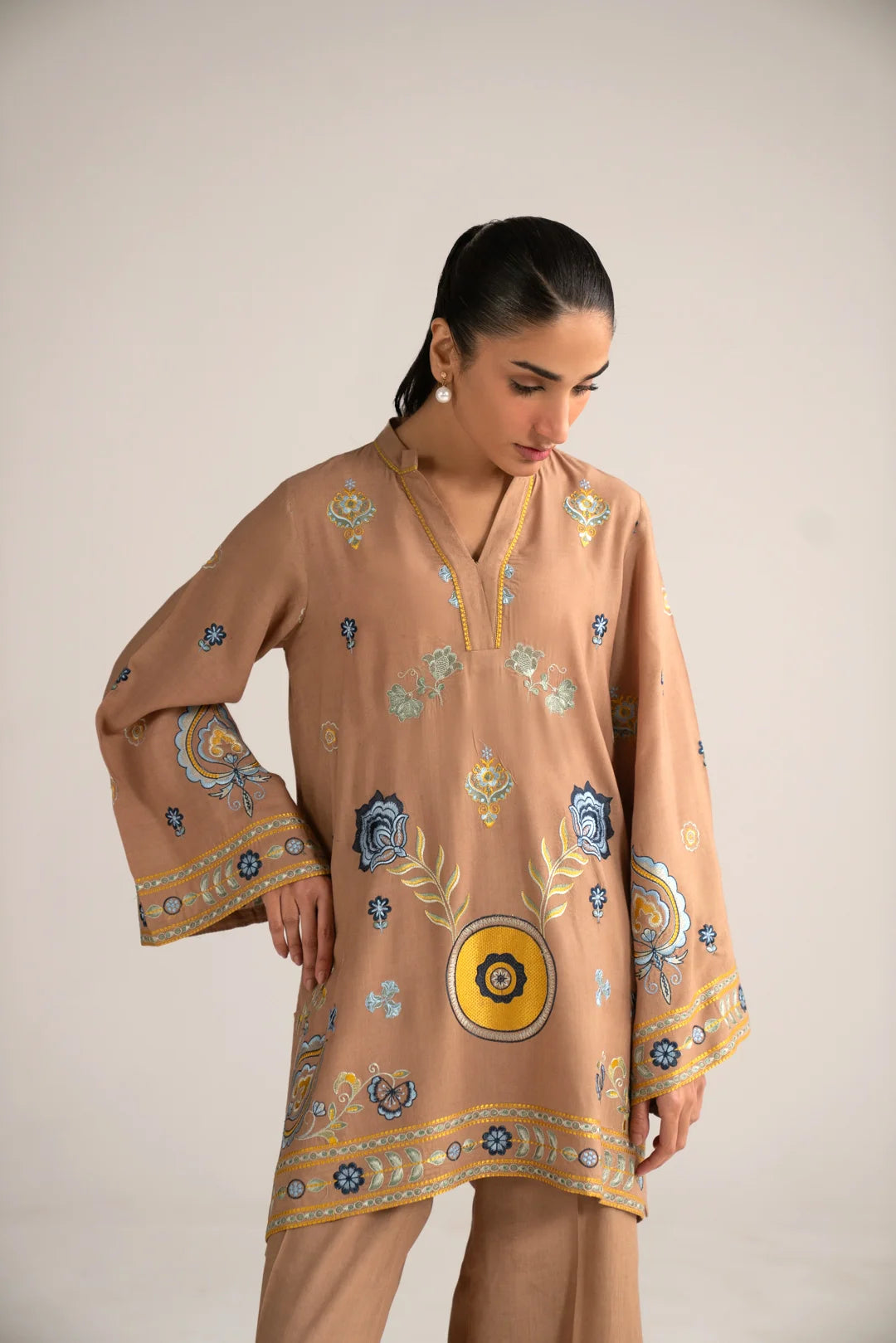 Close-up of beige embroidered linen shirt detail