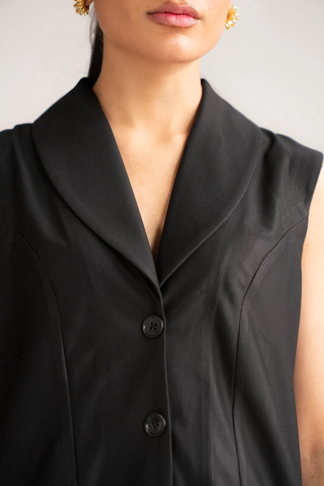 Close-up of black sleeveless cropped vest on women’s 2 piece co-ord set
