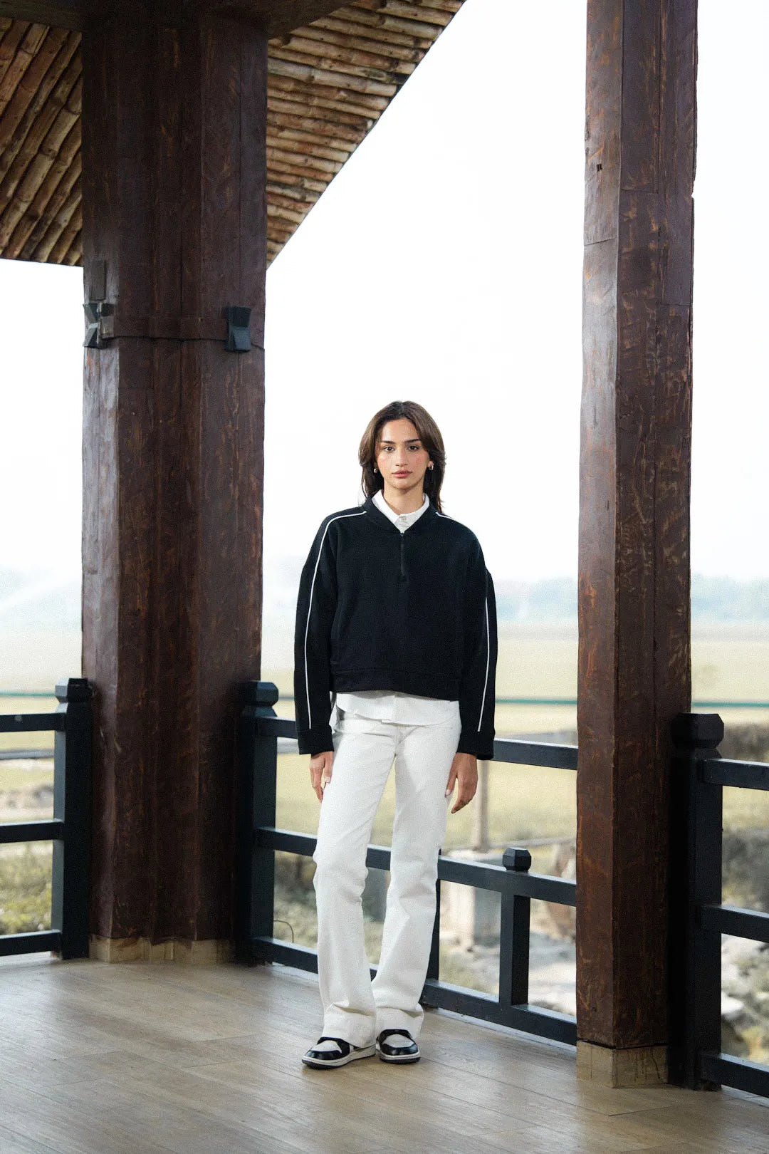 Close-up of contrast stripe detail on black sweatshirt sleeve