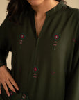 Close-up of deep green embroidered linen kurta front showing delicate motif placement and neckline detail.