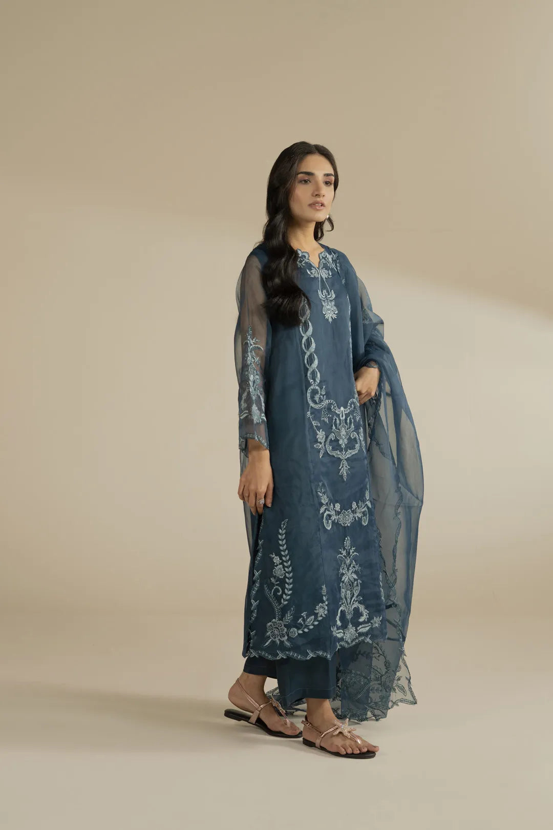 Close-up of embroidered neckline on a maroon organza formal suit for women