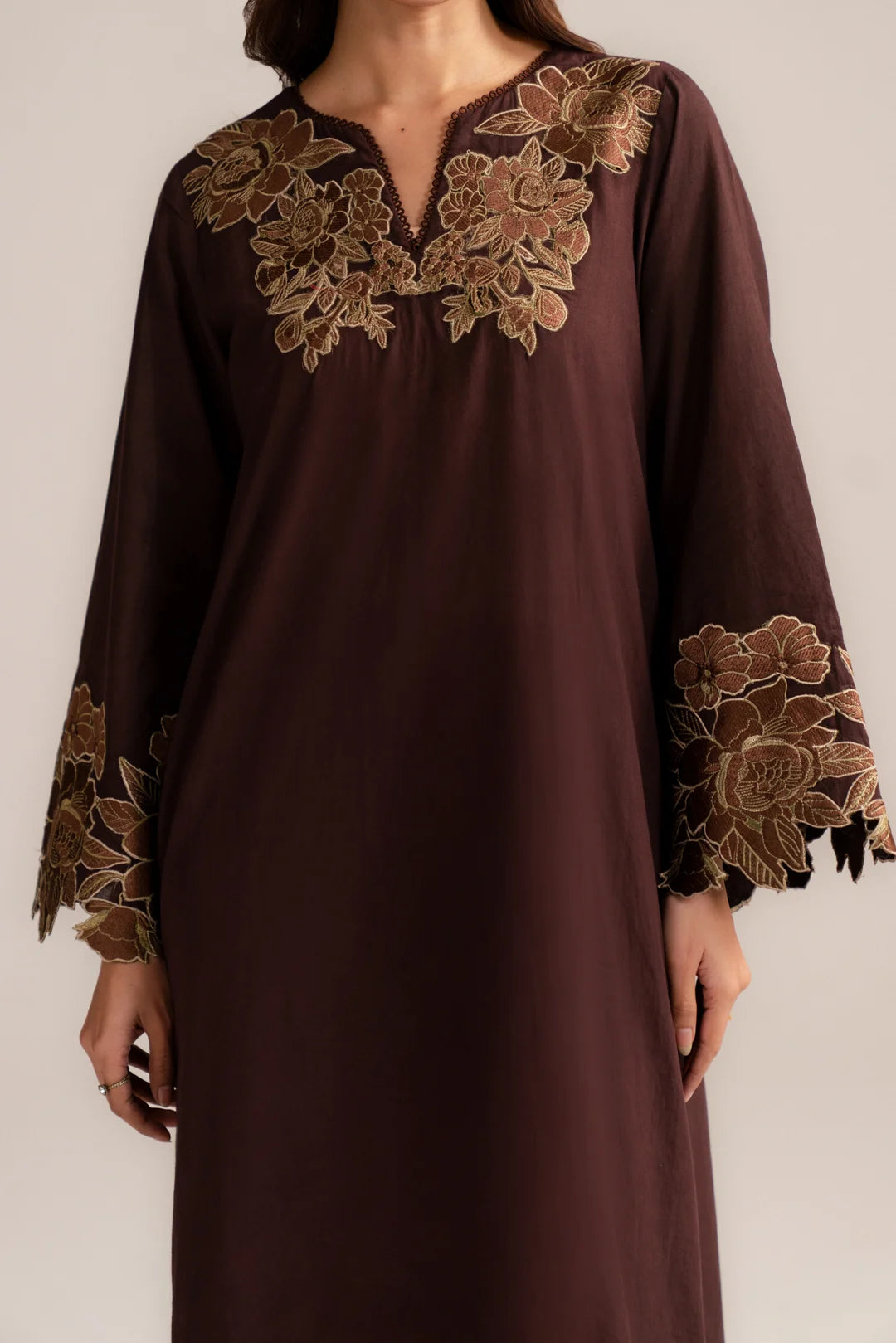 Close-up of embroidered neckline on brown ready-to-wear 2 piece suit