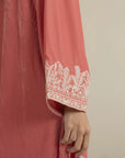 Close-up of embroidered neckline on peach velvet kaftan