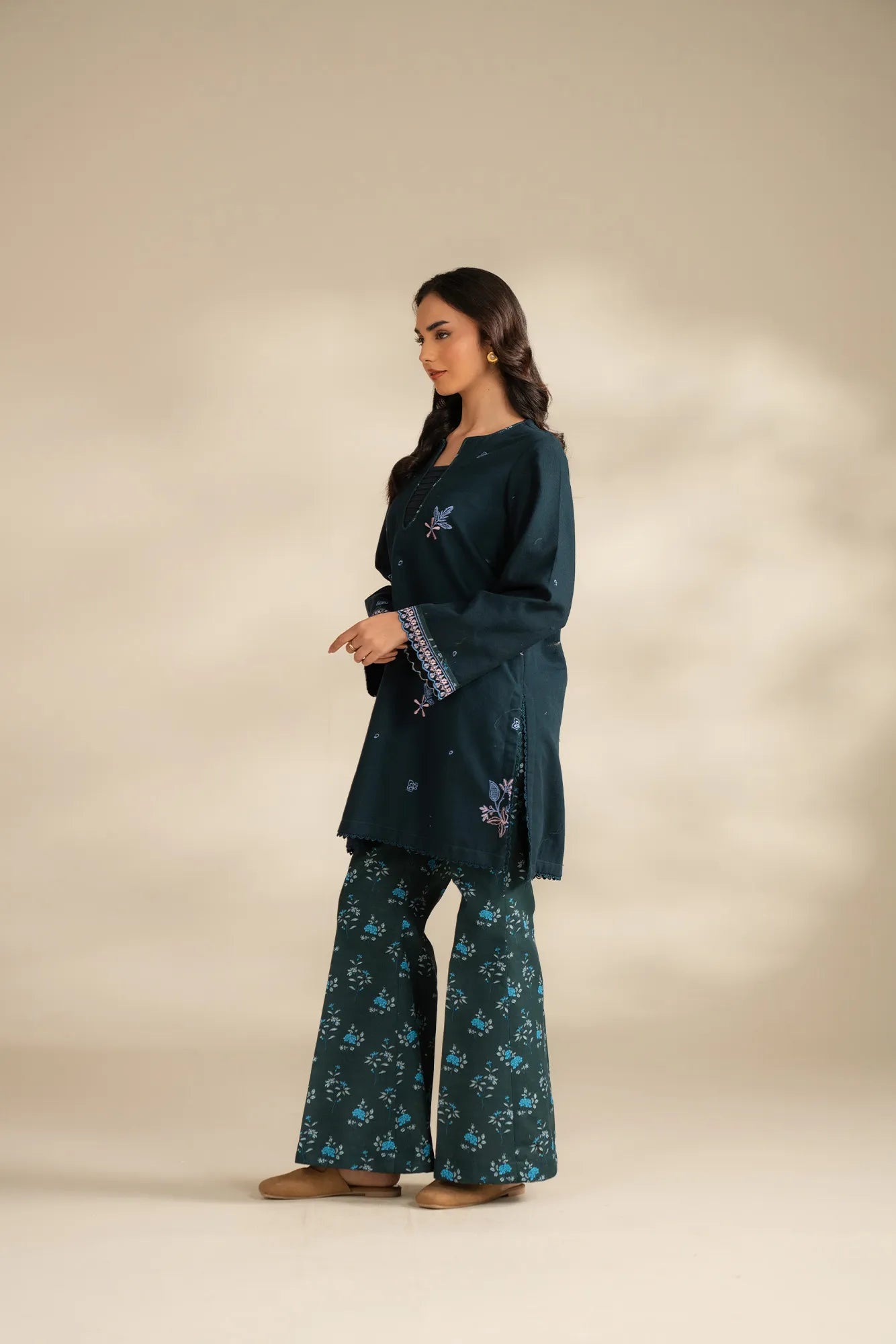 Close-up of embroidery detailing on green khaddar shirt front