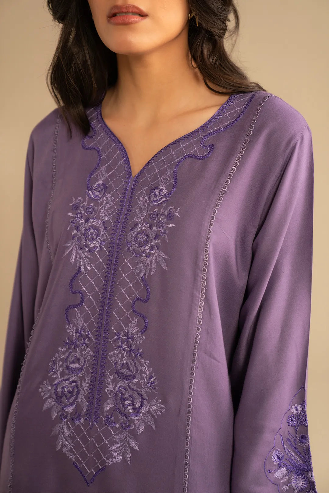 Close-up of light purple linen suit neckline featuring delicate embroidery detailing on the front