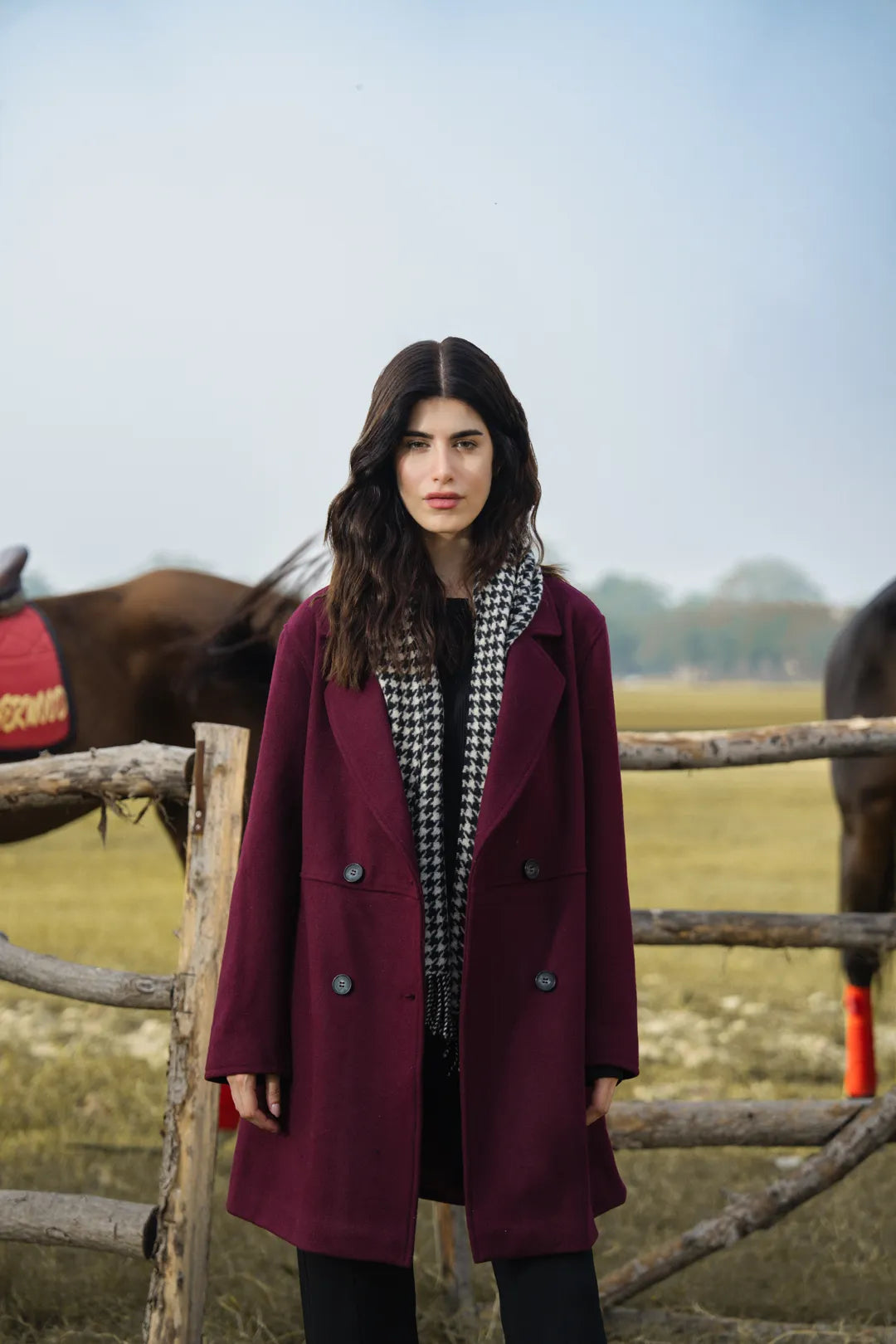 Close-up of maroon coat front opening and neckline, clean tailored finish