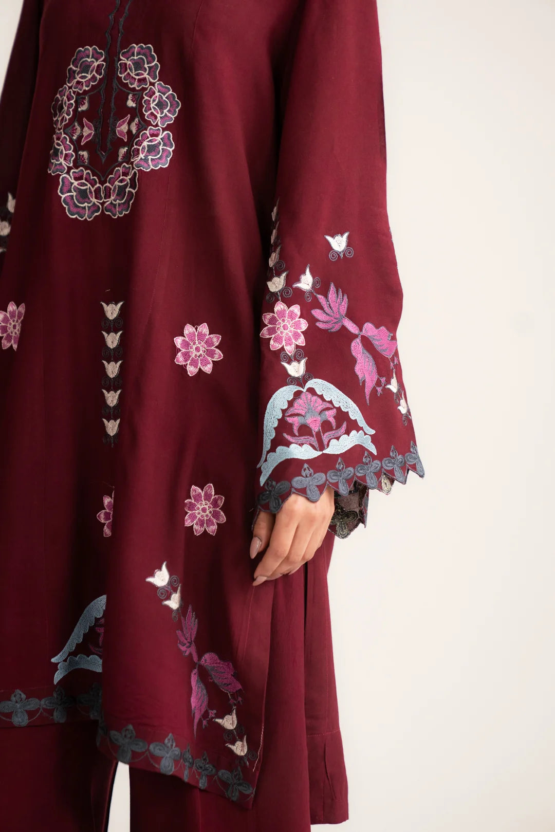 Close-up of maroon linen shirt embroidery and sleeve design