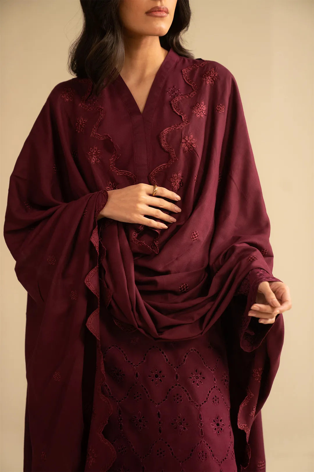 Close-up of maroon linen suit showing chikankari-style threadwork and dupatta drape detail.