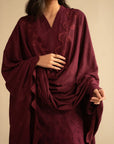 Close-up of maroon linen suit showing chikankari-style threadwork and dupatta drape detail.