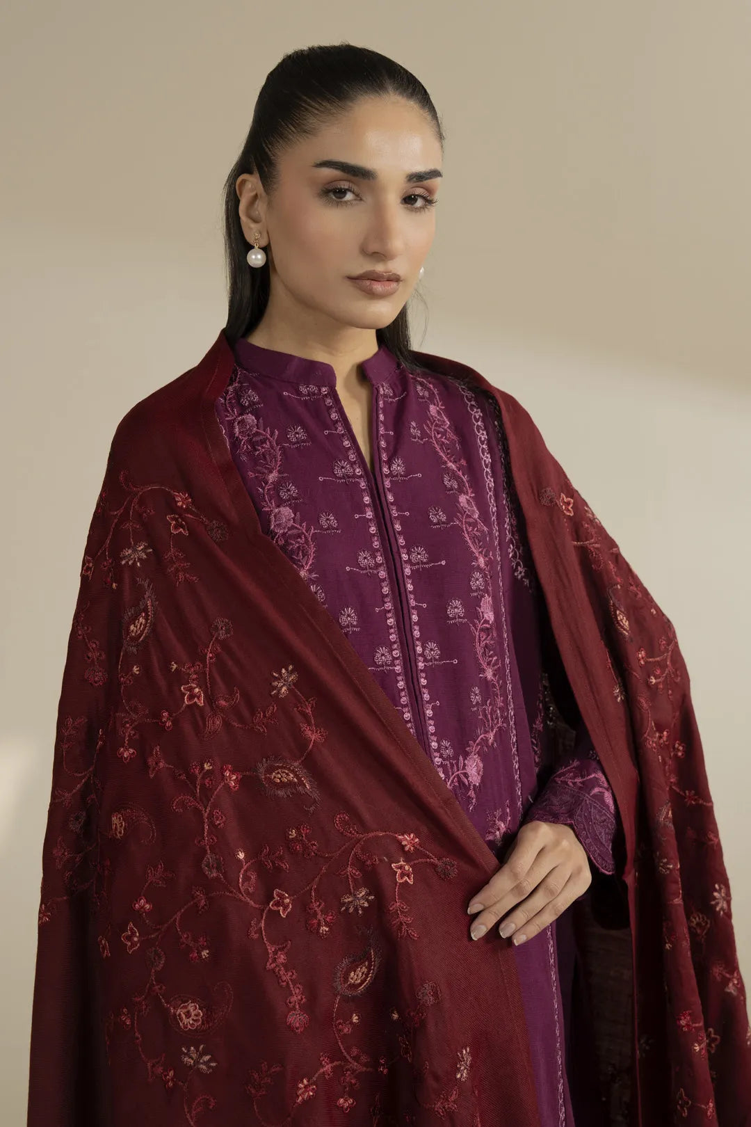 Close-up of maroon shawl embroidery pattern and texture