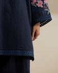 Close-up of navy blue trouser/hem finish showing clean stitching and fabric texture.