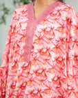 Close-up of pink floral print and neckline detail on the kaftan