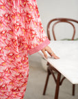 Close-up of pink printed kaftan fabric and sleeve detail