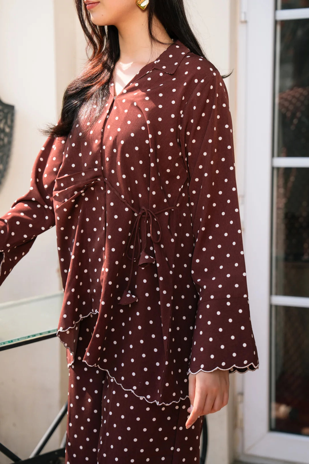 Close-up of polka dot silk shirt in chocolate brown