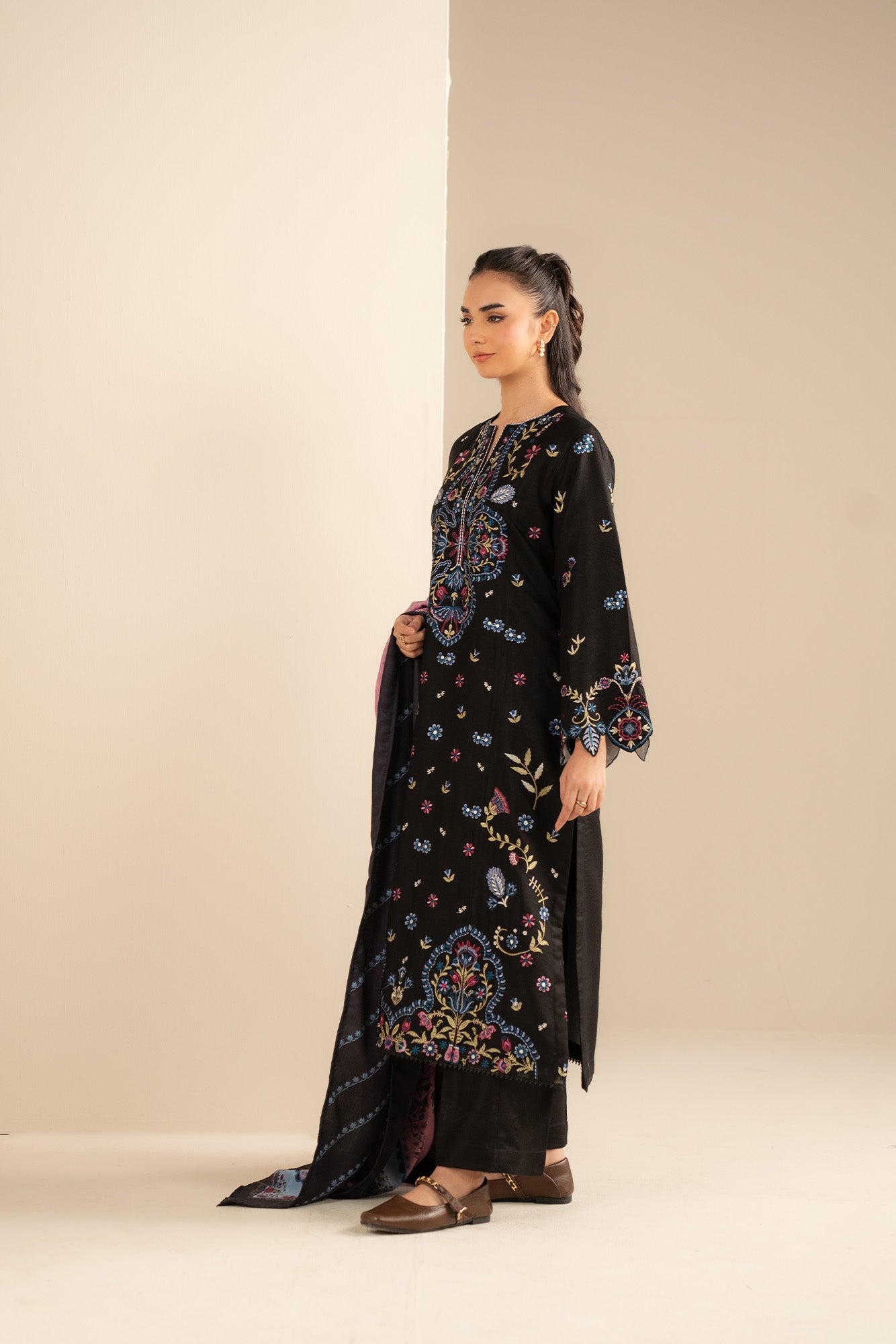 Close-up of printed herringbone shawl pattern and border detail while draped on the shoulder.