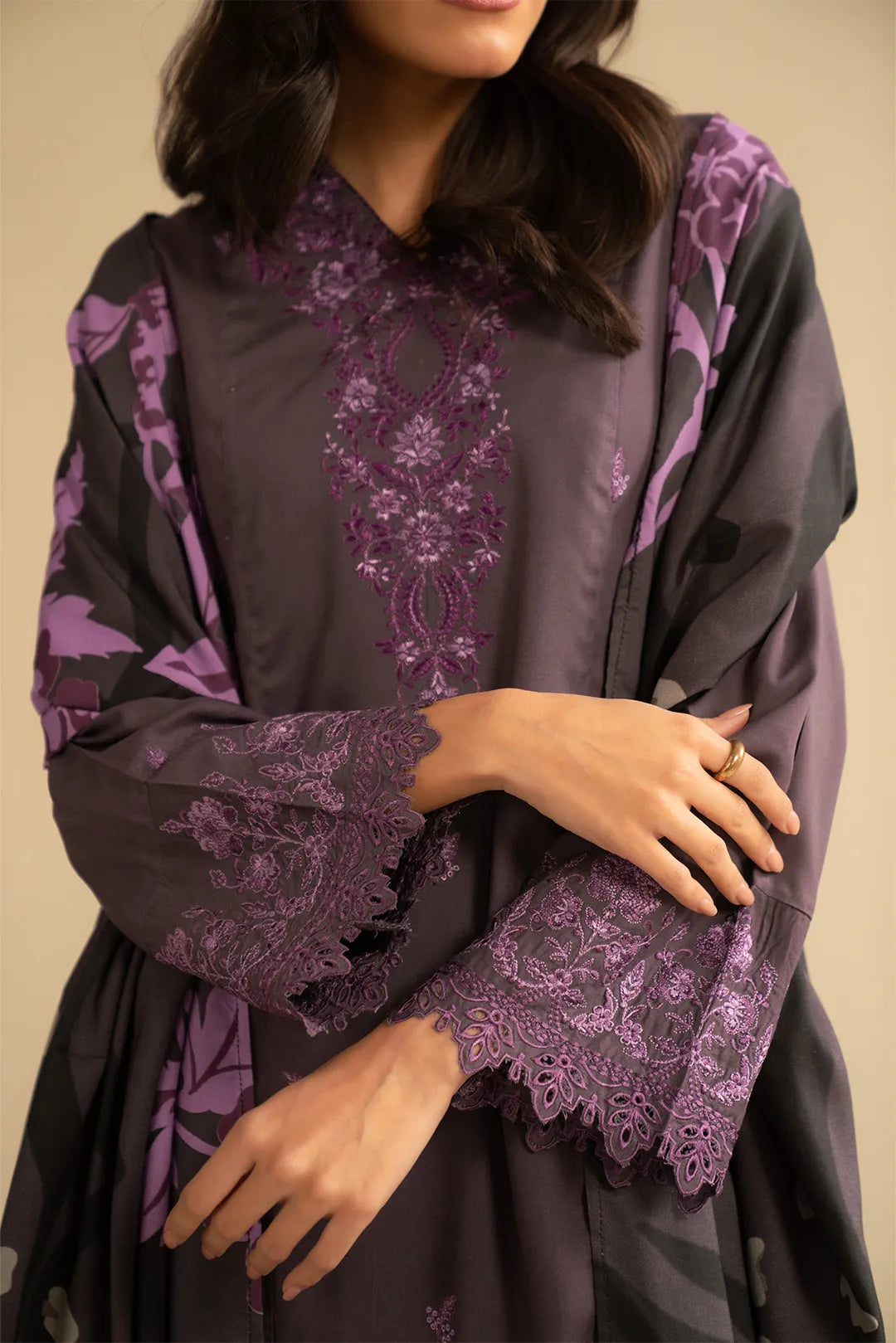 Close-up of purple embroidered linen kurta showing floral motifs and sleeve detailing