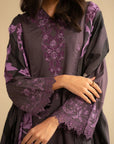 Close-up of purple embroidered linen kurta showing floral motifs and sleeve detailing