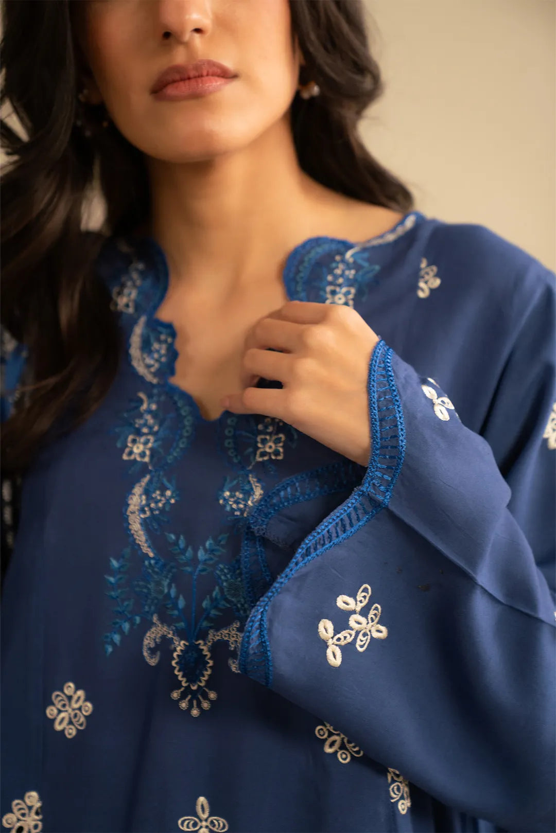 Close-up of royal blue embroidered linen kurta showing neckline and sleeve embroidery details