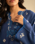 Close-up of royal blue embroidered linen kurta showing neckline and sleeve embroidery details