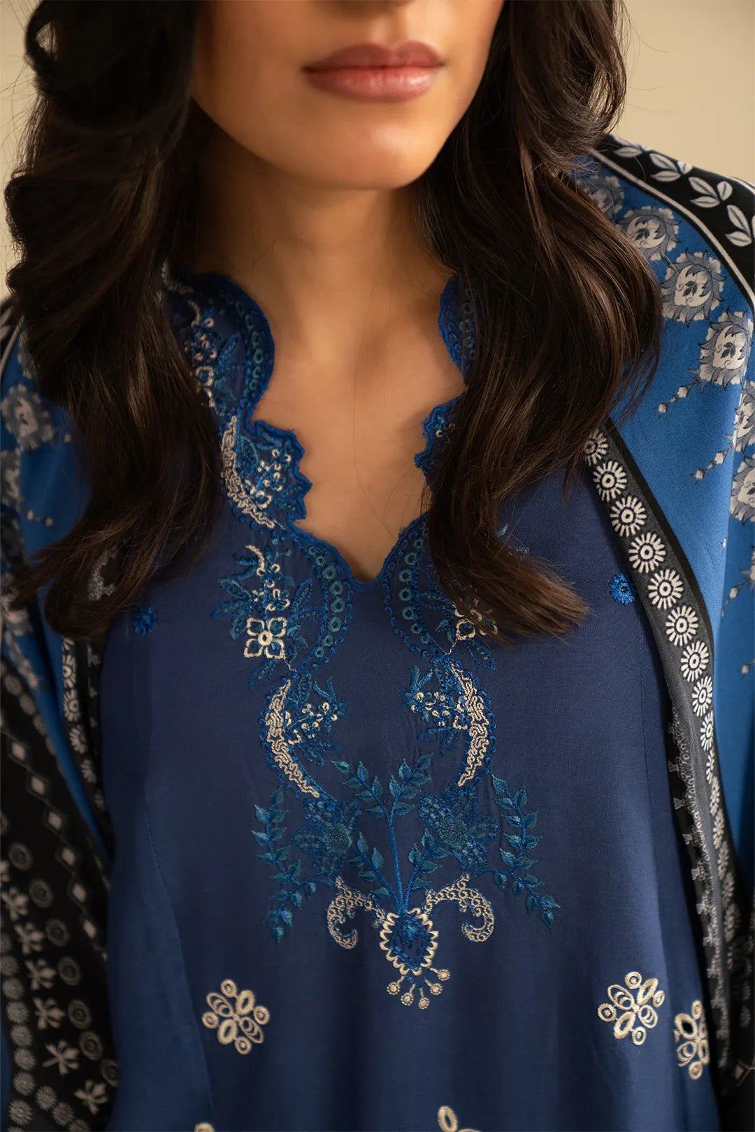 Close-up of royal blue embroidered linen suit front motifs and neckline detailing