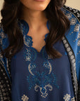 Close-up of royal blue embroidered linen suit front motifs and neckline detailing