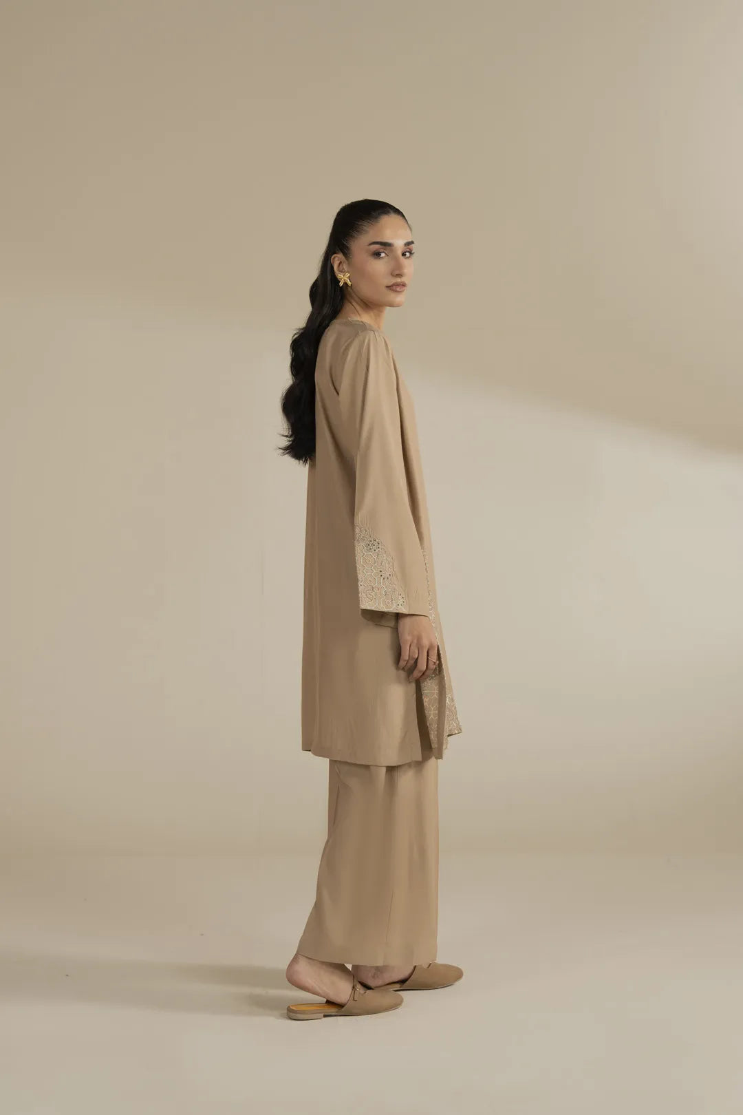 Close-up of sleeve embroidery detail on beige blended suit for women in Pakistan.