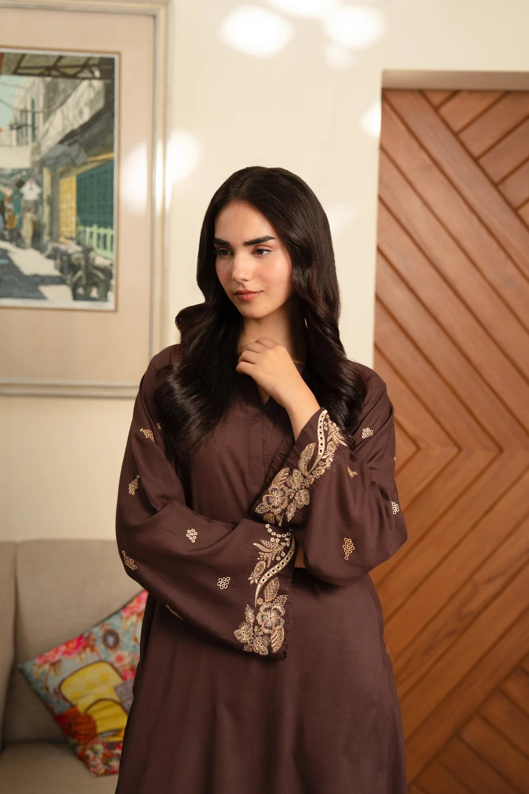 Close-up of sleeve embroidery on brown linen shirt