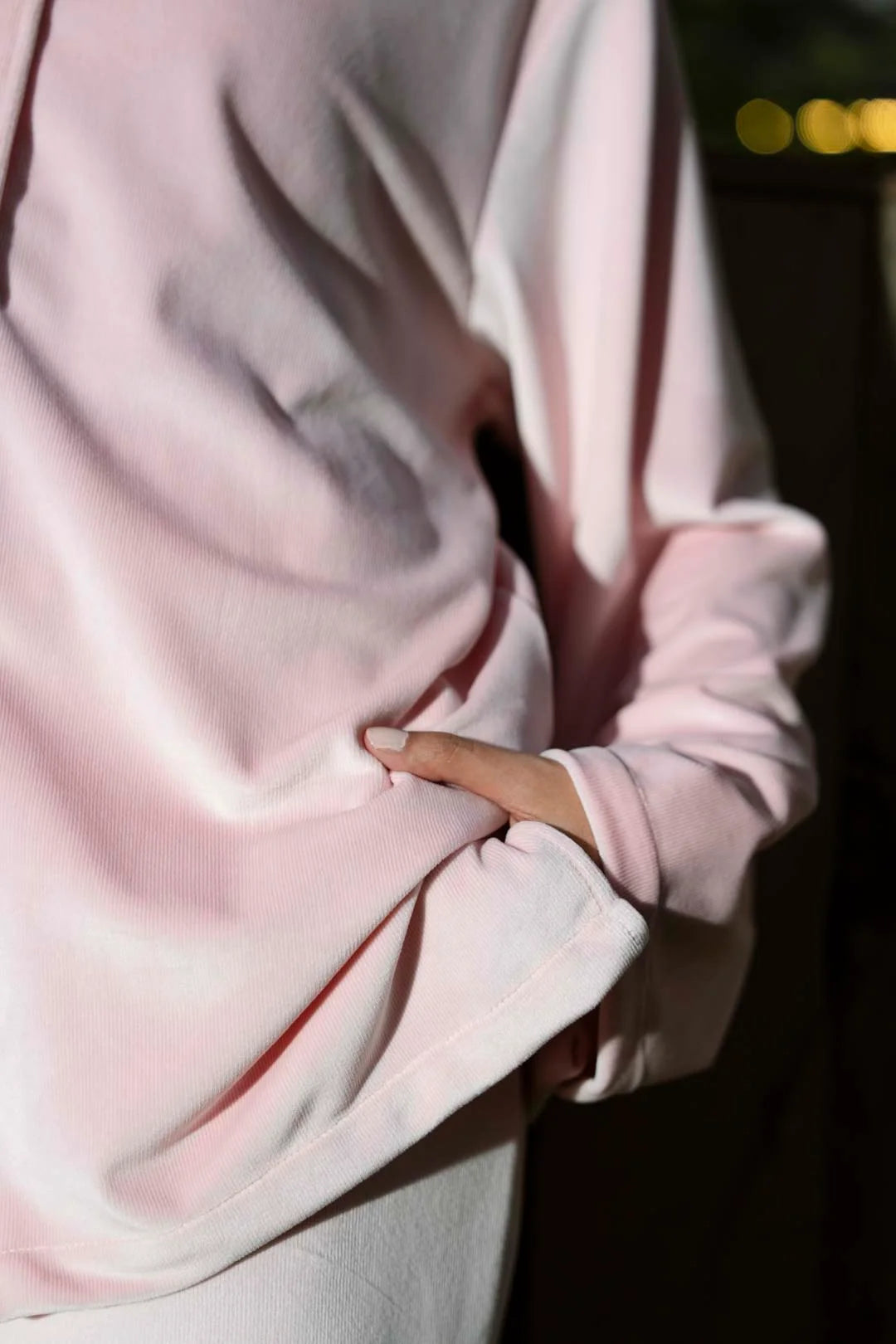 Close-up of soft pink velvet shirt neckline and collar detail