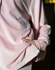 Close-up of soft pink velvet shirt neckline and collar detail