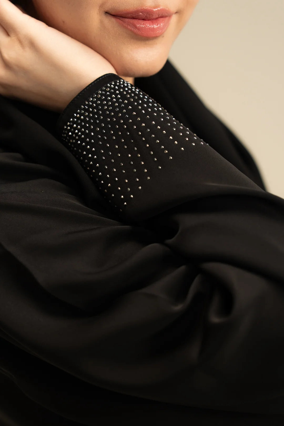 Close-up of stone detailing on black abaya sleeve – WTSE161196 Beyond East