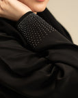 Close-up of stone detailing on black abaya sleeve – WTSE161196 Beyond East