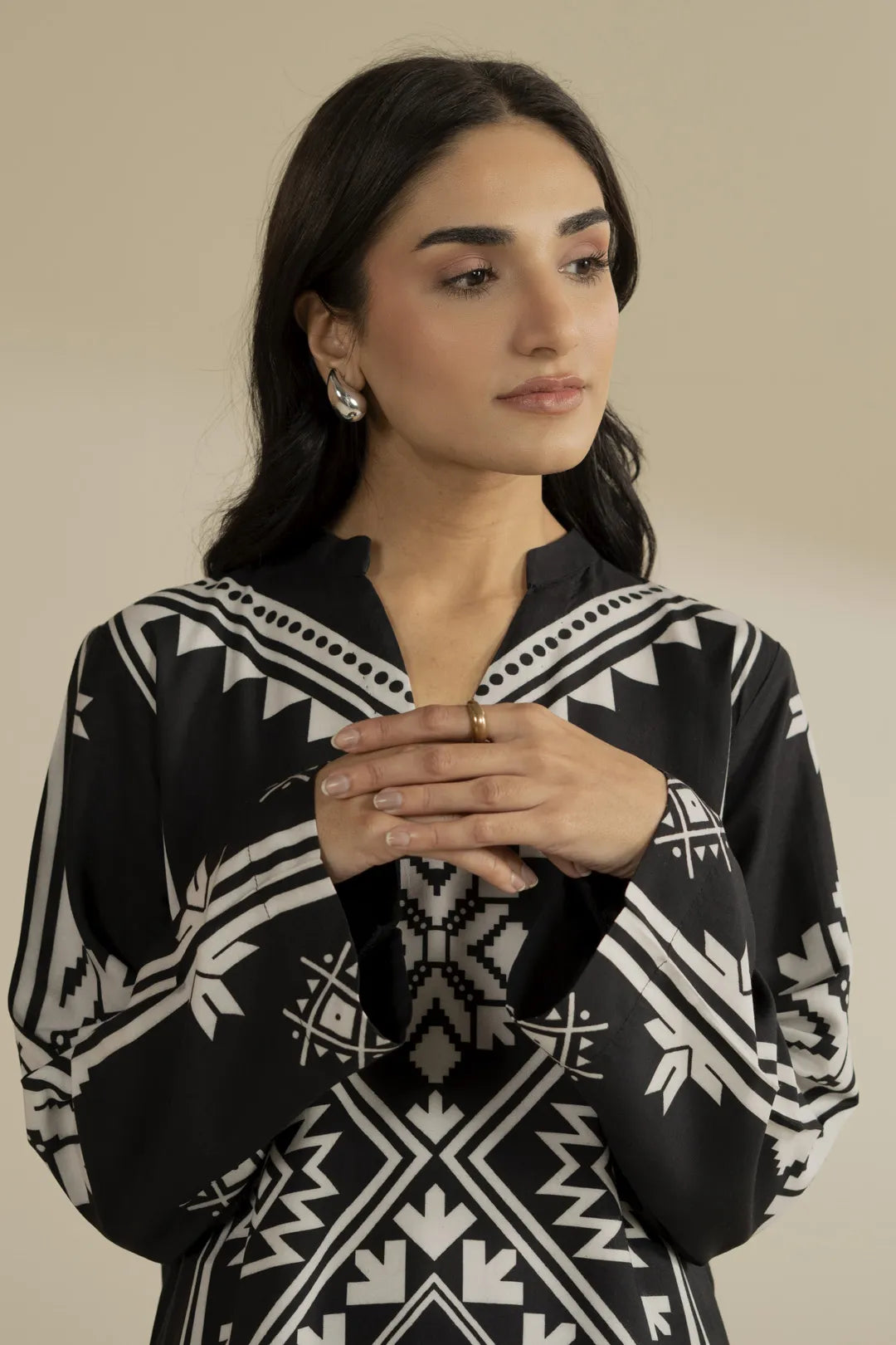 Close-up of white geometric motif detailing on the black printed linen fabric