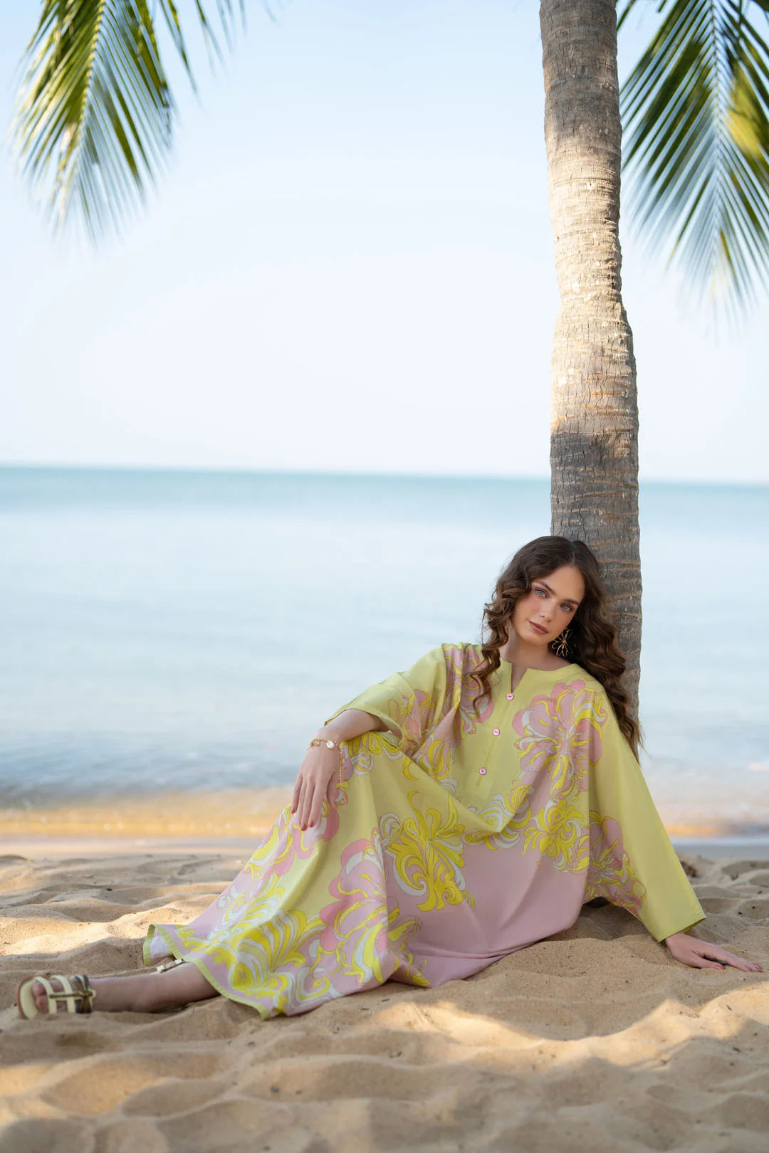 Close-up of yellow printed kaftan fabric and sleeve