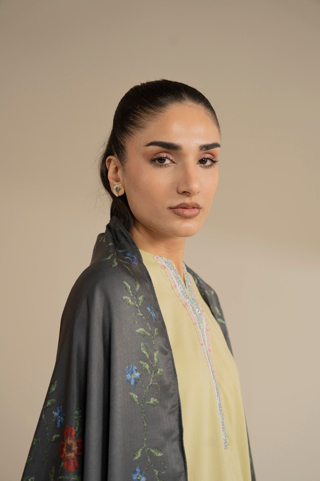 Close-up portrait with dark green printed dupatta highlighting border and print detail near the face.