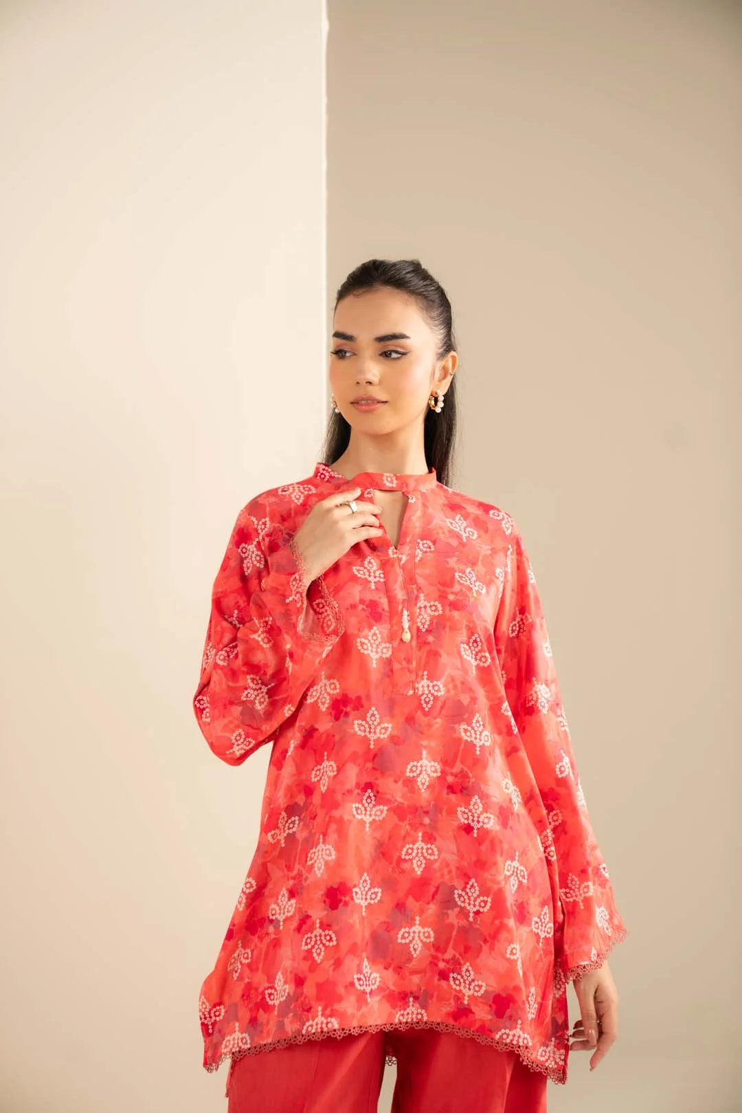 Close framing on the printed shirt front to capture color contrast, pattern detail, and neckline finish.