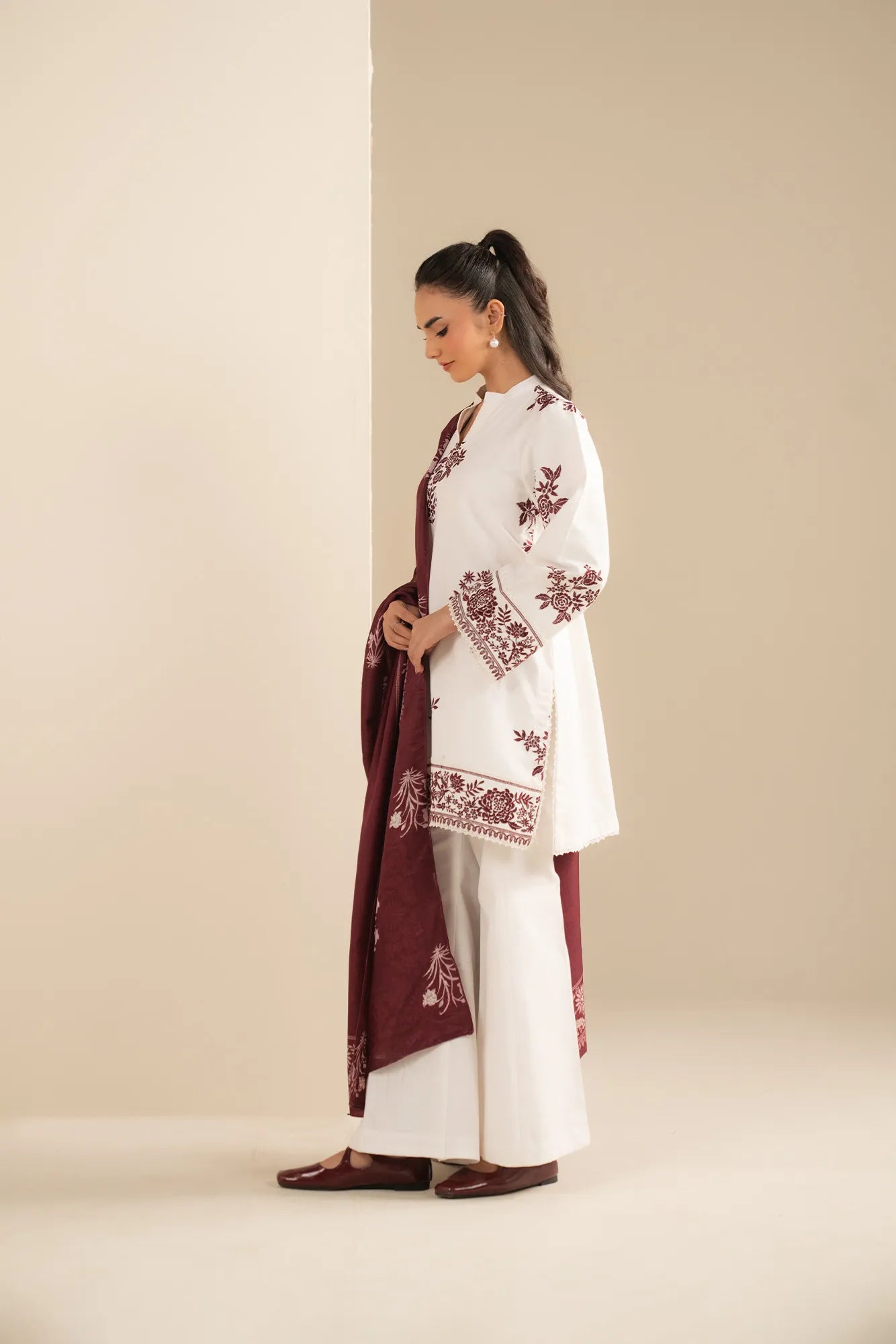 Close view of embroidered motif placement on khaddar shirt front