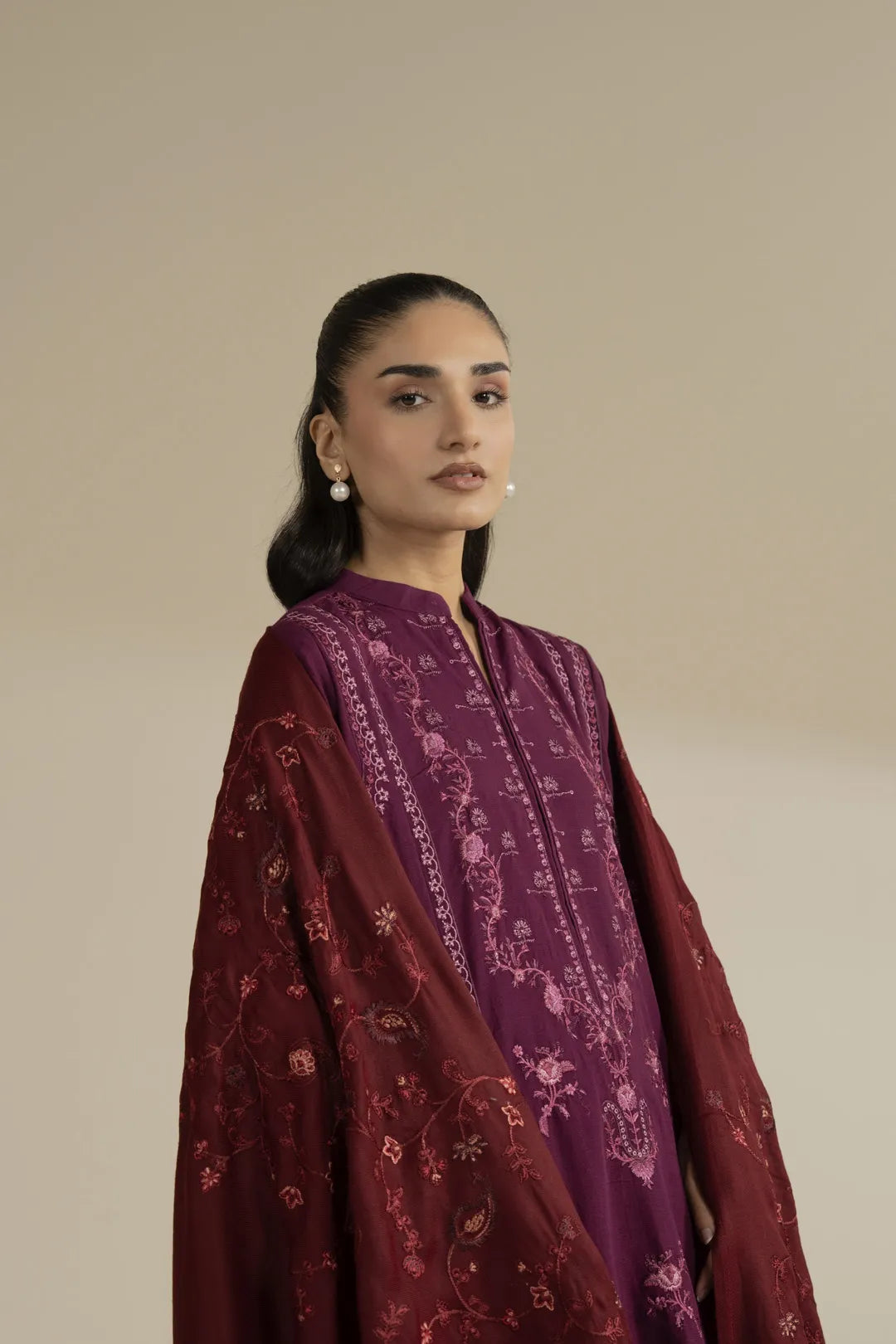 Close view of maroon embroidered shawl detailing around shoulders
