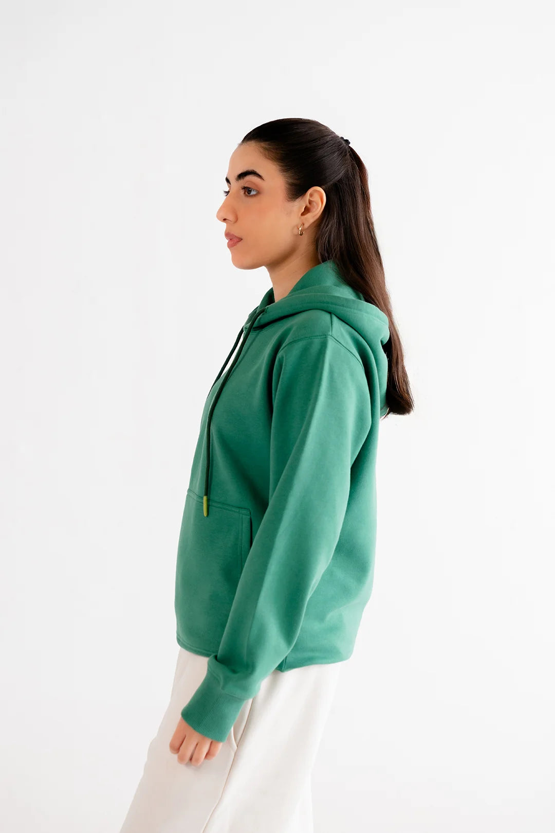 Comfortable green hoodie with a relaxed fit, styled for a minimalist and trendy casual look.