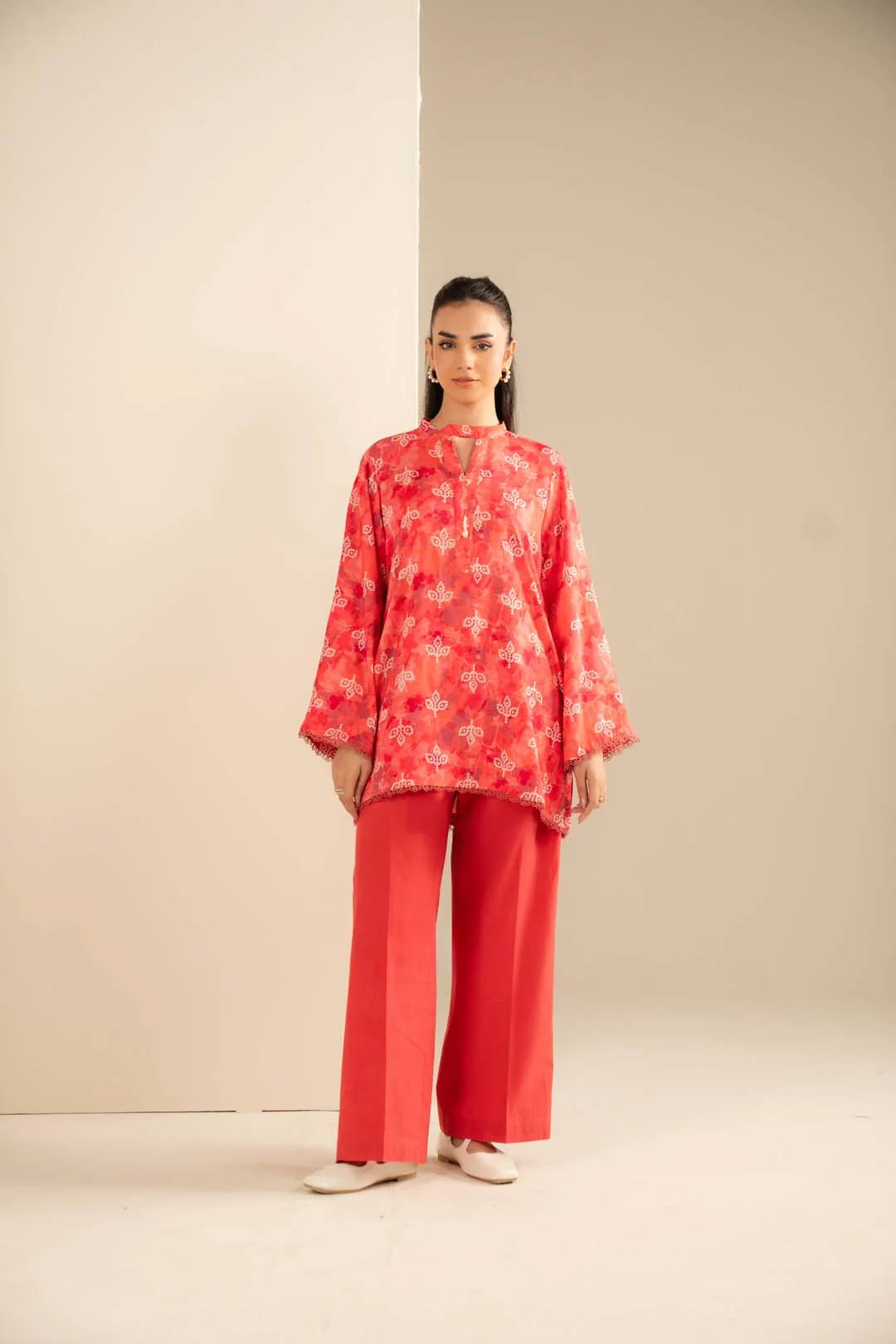 Coral Marina print shirt styled with matching plain trousers, full outfit shown against a neutral studio background.