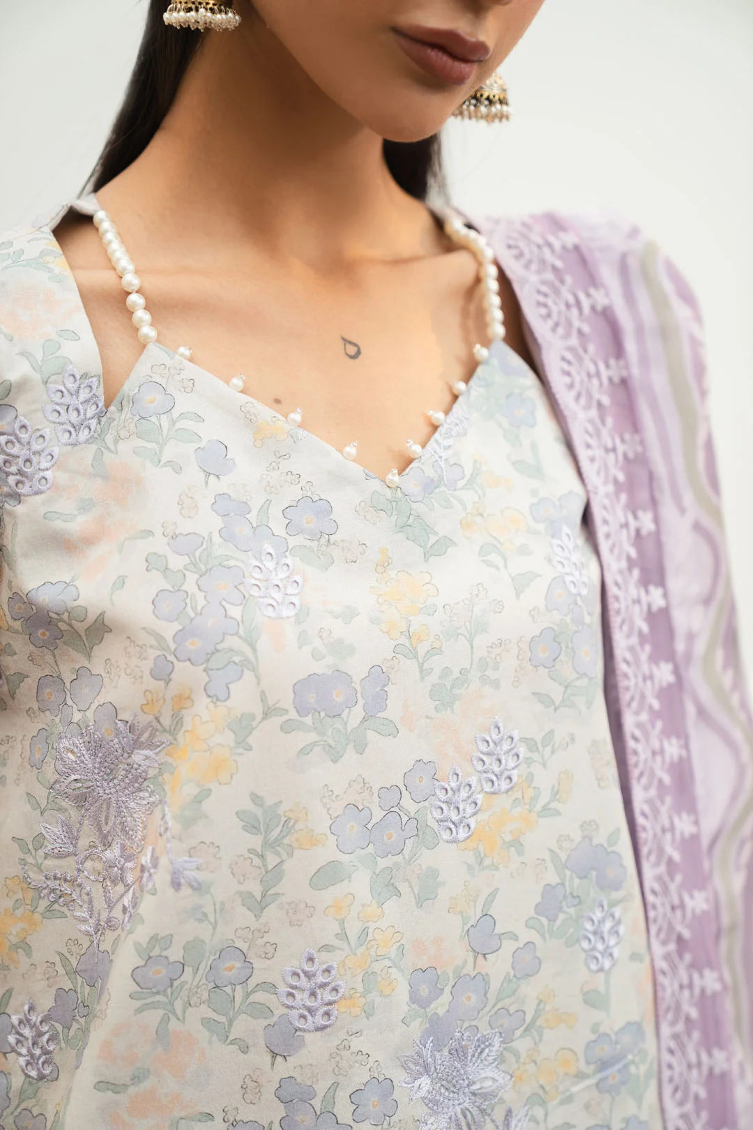 Cream unstitched lawn suit close up floral print neckline embroidery detail Pakistan summer 2026 Beyond East